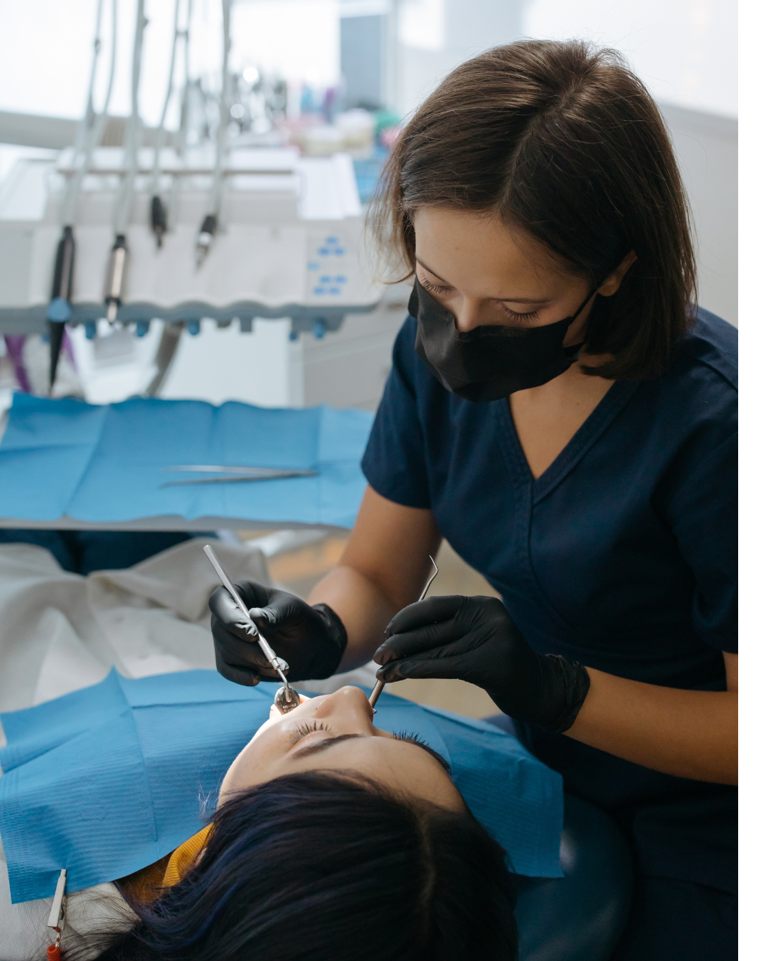 A person is getting their teeth cleaned by a dentist.